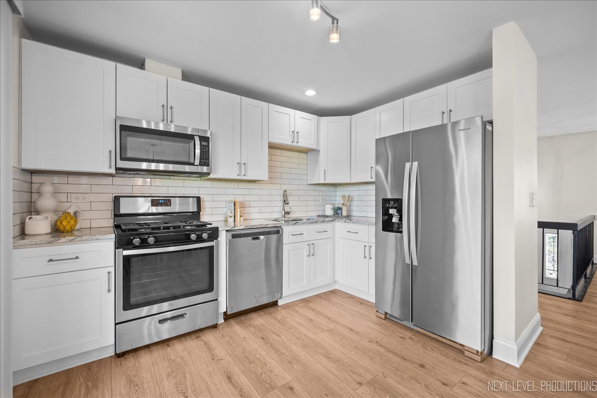 5628 Crestwood Road Matteson, IL 60443 - Photo 3 of 29 a kitchen with a refrigerator stove and microwave