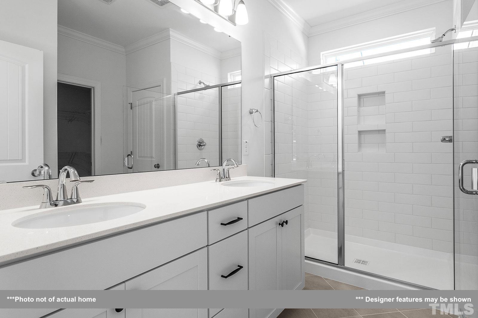 201 Dungannon Loop Clayton, NC 27520 - Photo 13 of 35 a bathroom with a double vanity sink mirror and shower