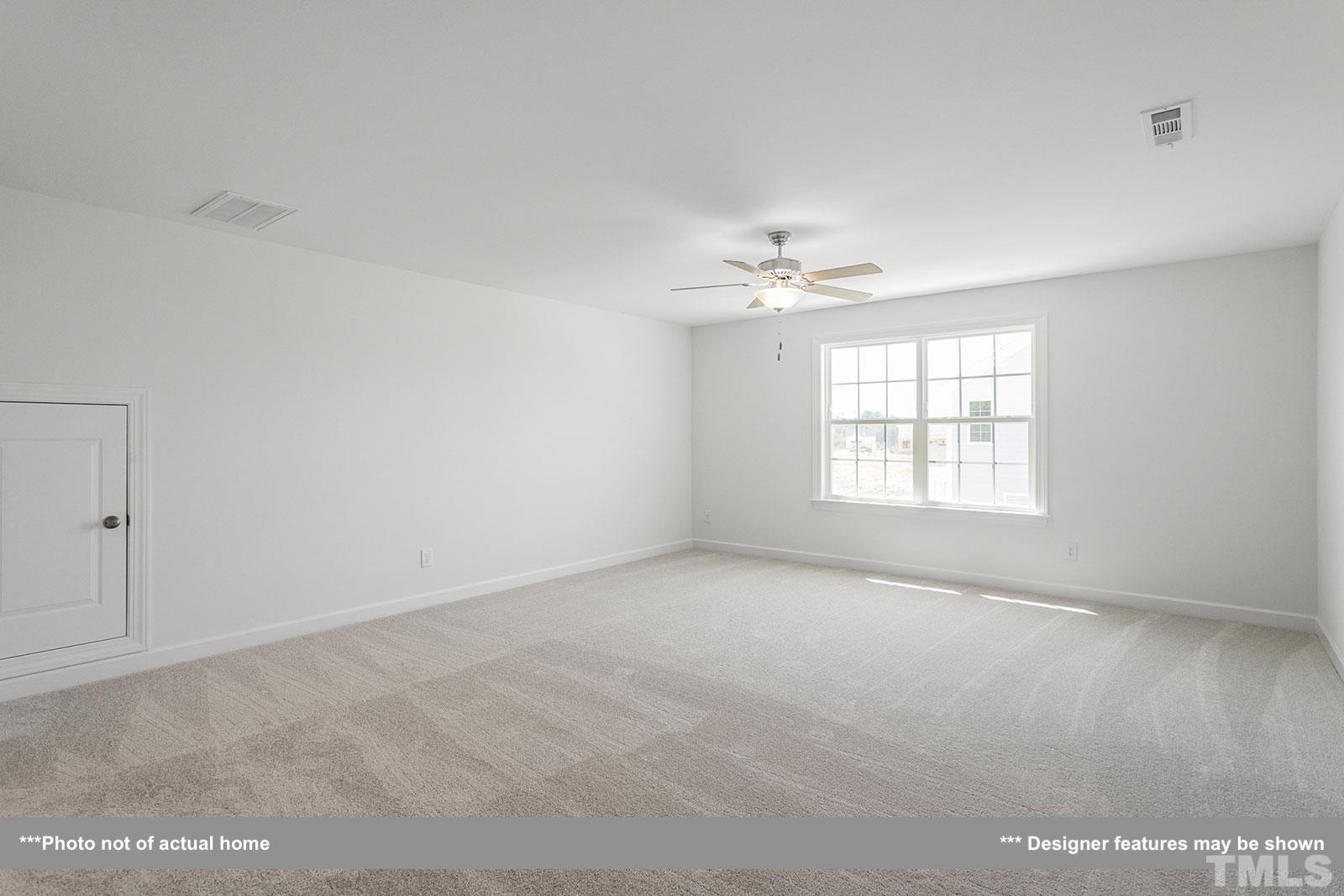 201 Dungannon Loop Clayton, NC 27520 - Photo 18 of 35 an empty room with windows and chandelier fan