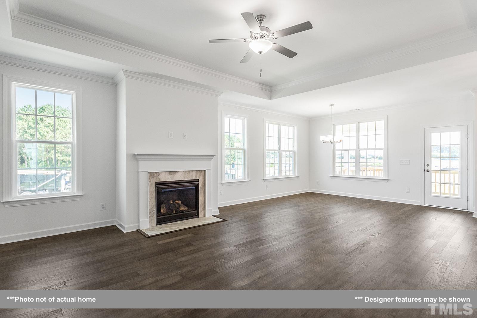 201 Dungannon Loop Clayton, NC 27520 - Photo 4 of 35 a view of an empty room with wooden floor and a window