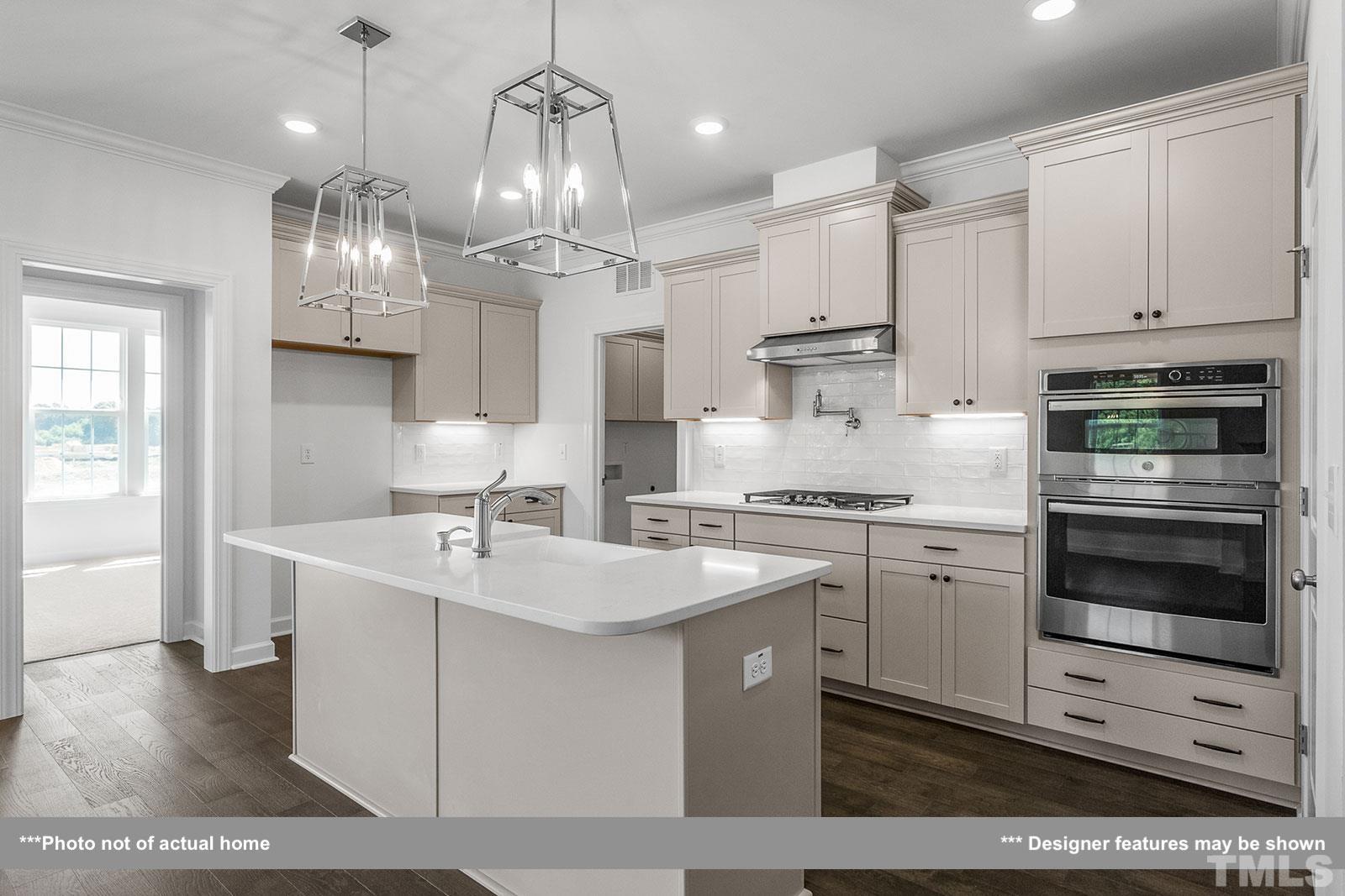 201 Dungannon Loop Clayton, NC 27520 - Photo 7 of 35 a kitchen with a sink stainless steel appliances and cabinets