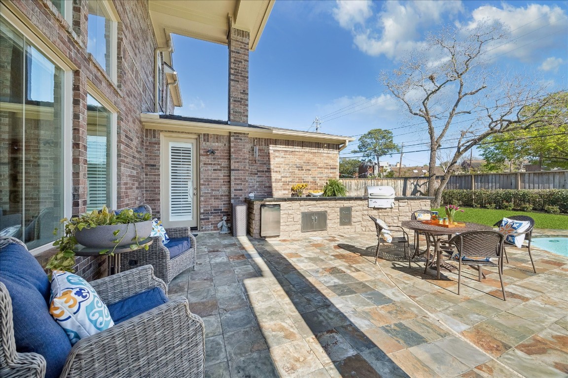 3711 Drake Street Houston, TX 77005 - Photo 4 of 34 Outdoor kitchen with covered seating and built-in serving area and BBQ grill.