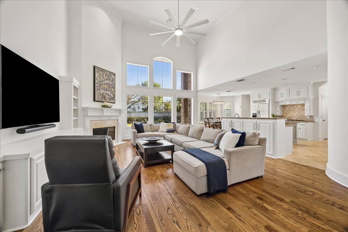 3711 Drake Street Houston, TX 77005 - Photo 5 of 34 Family room open to kitchen with 2-story ceilings and wall of windows overlooking the backyard.