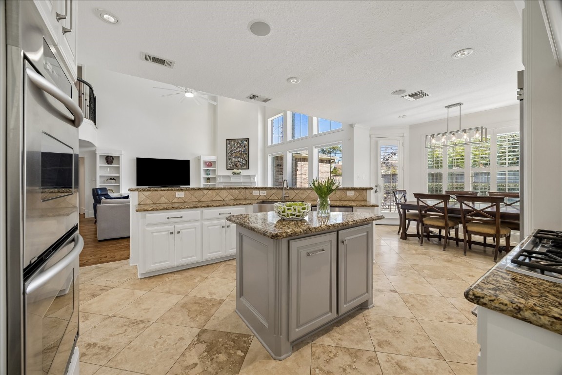 3711 Drake Street Houston, TX 77005 - Photo 8 of 34 Large open kitchen with island, open to family and informal dining area, all overlooking the beautiful backyard.