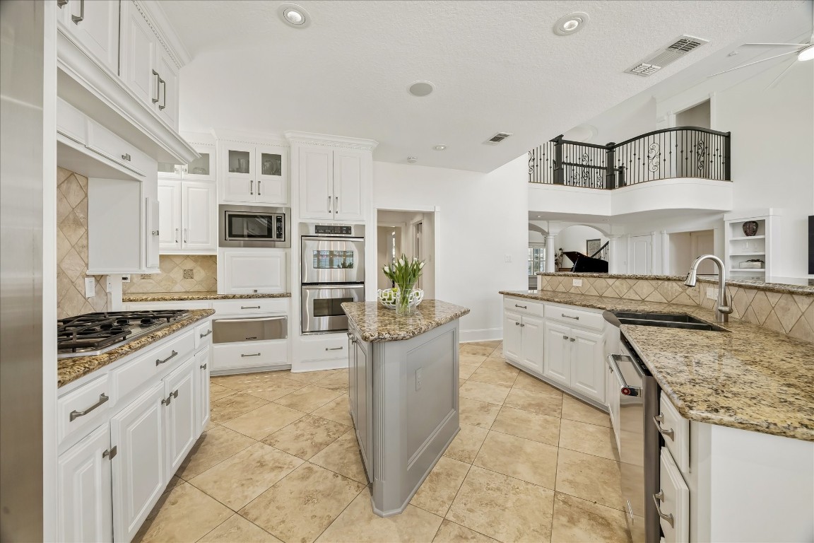 3711 Drake Street Houston, TX 77005 - Photo 9 of 34 The perfect working kitchen, with cooktop, double ovens, island, serving bar, and plenty of counter space and cabinets.
