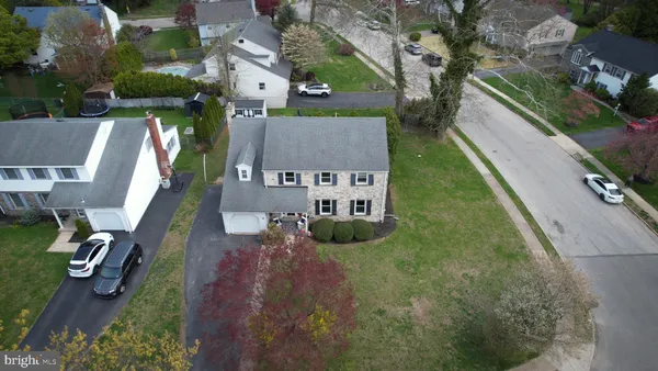 an aerial view of residential houses with outdoor space and parking