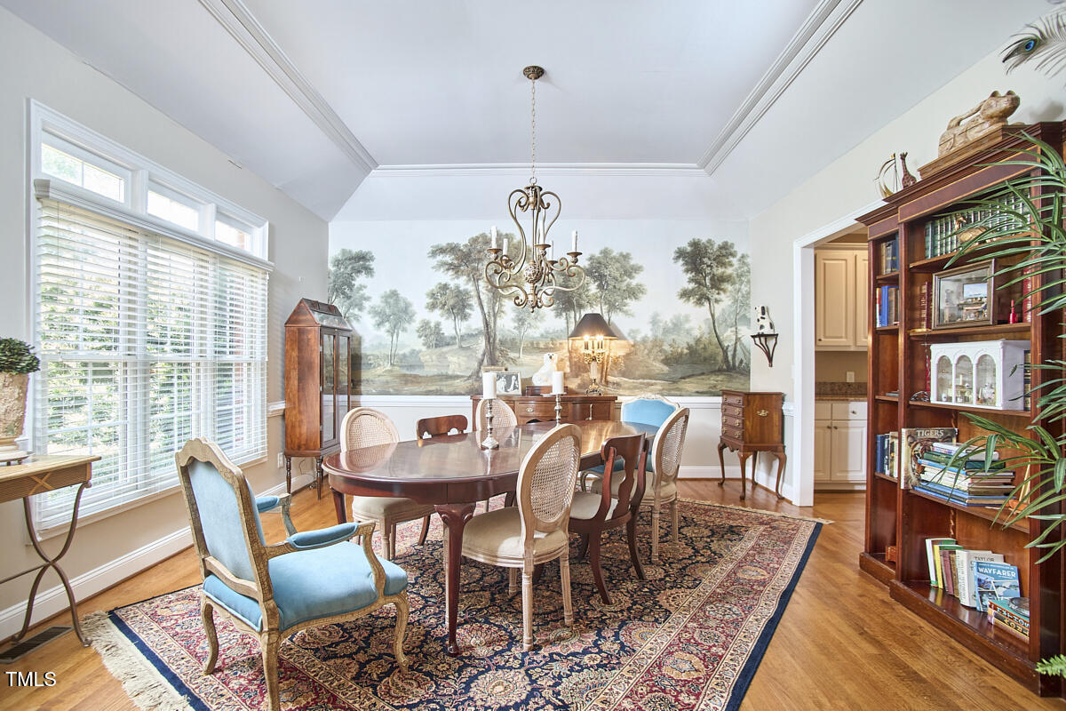 1344 Longleaf Drive Fayetteville, NC 28305 - Photo 16 of 46 a view of a dining room with furniture a rug and wooden floor