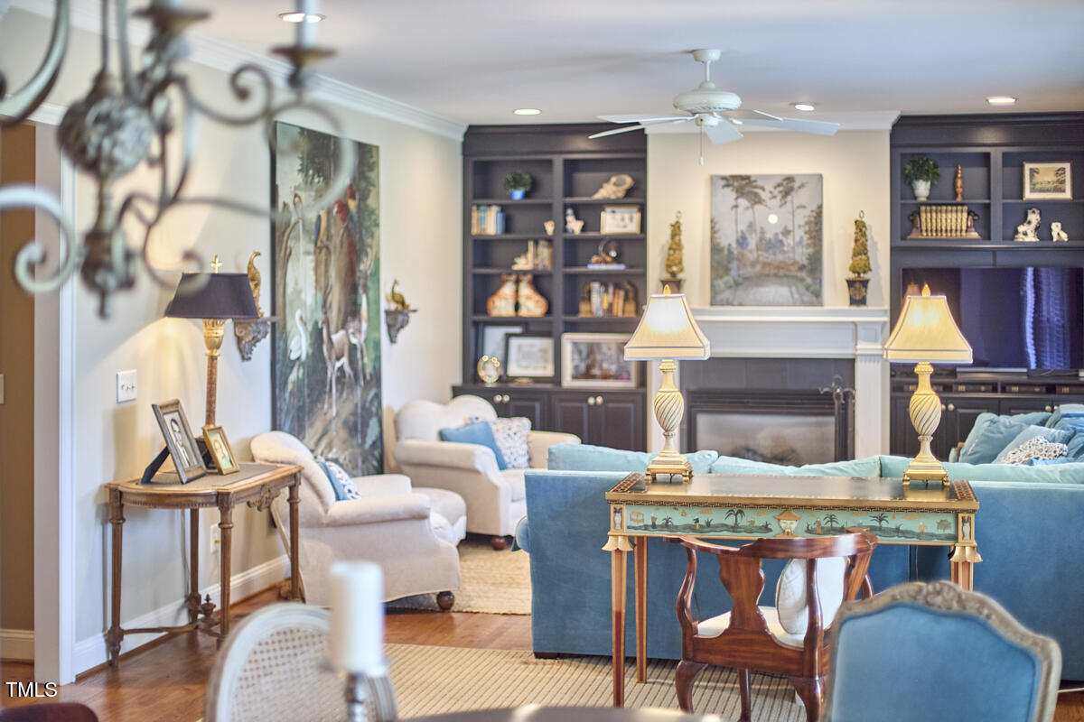 1344 Longleaf Drive Fayetteville, NC 28305 - Photo 24 of 46 a living room with furniture a fireplace and a chandelier