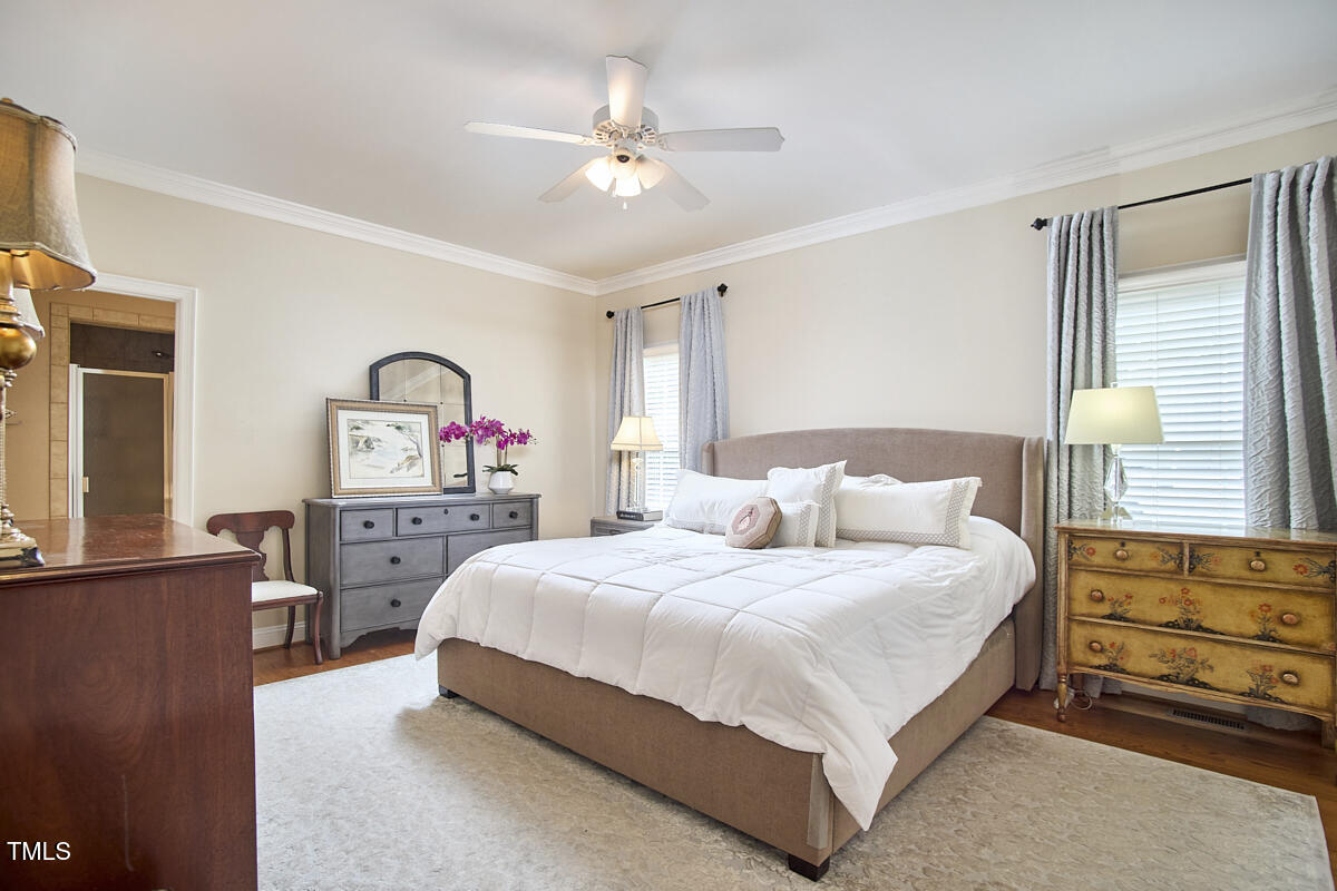 1344 Longleaf Drive Fayetteville, NC 28305 - Photo 30 of 46 a bedroom with a large bed and a chandelier