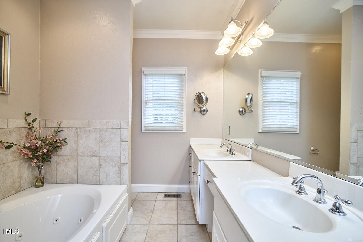 1344 Longleaf Drive Fayetteville, NC 28305 - Photo 33 of 46 a bathroom with a tub a sink and mirror
