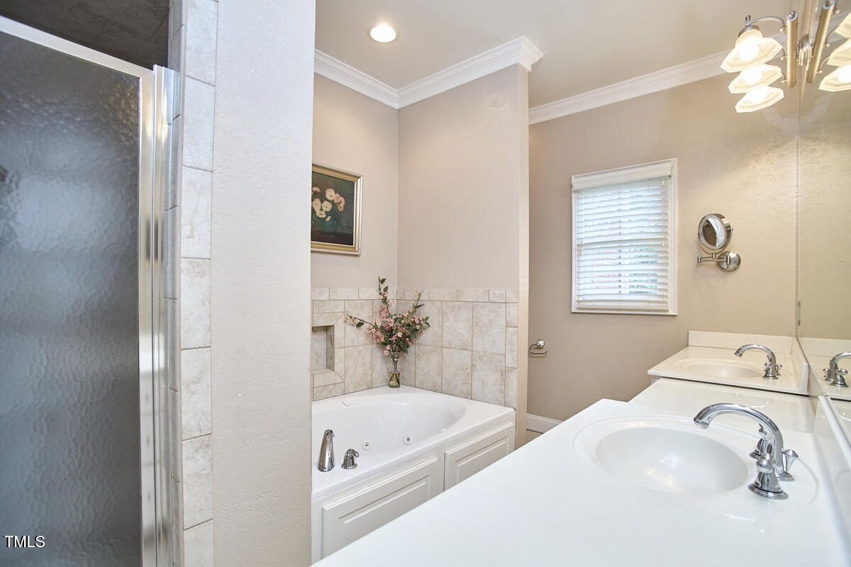 1344 Longleaf Drive Fayetteville, NC 28305 - Photo 34 of 46 a en suite spacious bathroom with a tub sink and mirror