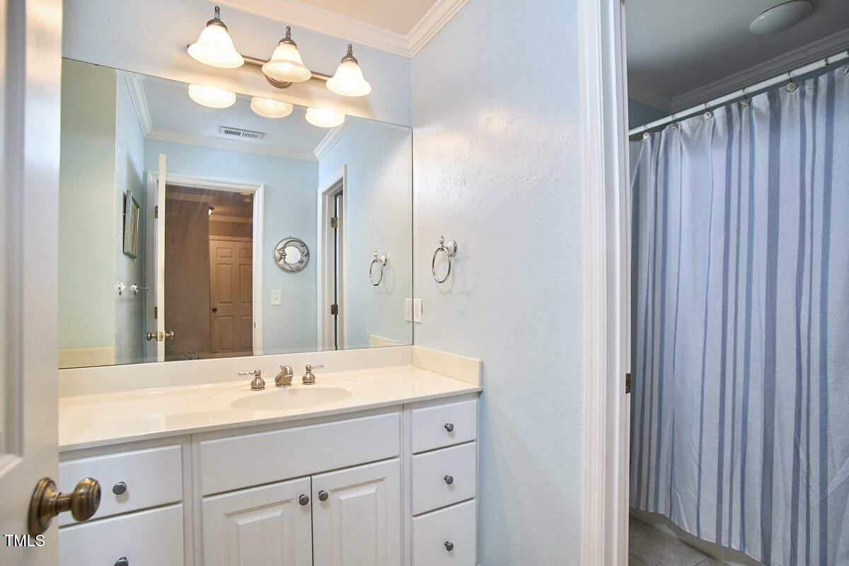 1344 Longleaf Drive Fayetteville, NC 28305 - Photo 39 of 46 a bathroom with a sink vanity and a mirror