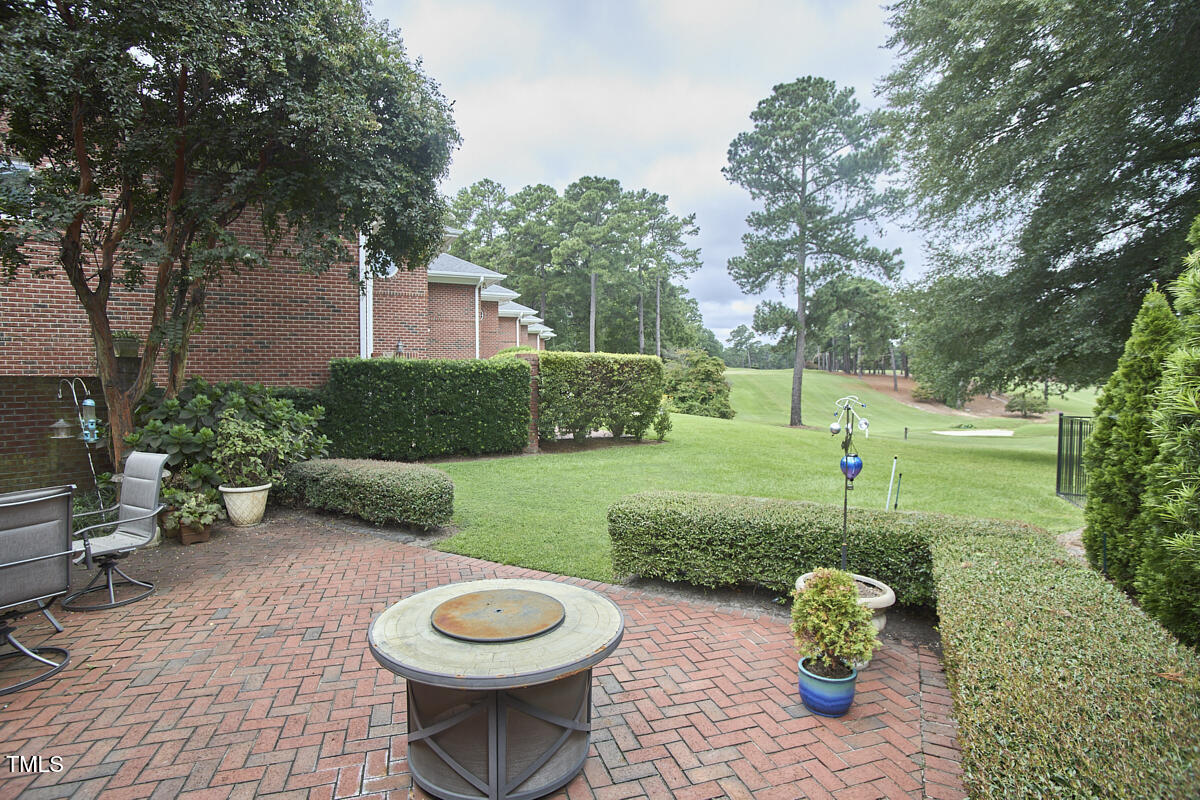 1344 Longleaf Drive Fayetteville, NC 28305 - Photo 4 of 46 a view of a backyard with table and chairs potted plants and large tree
