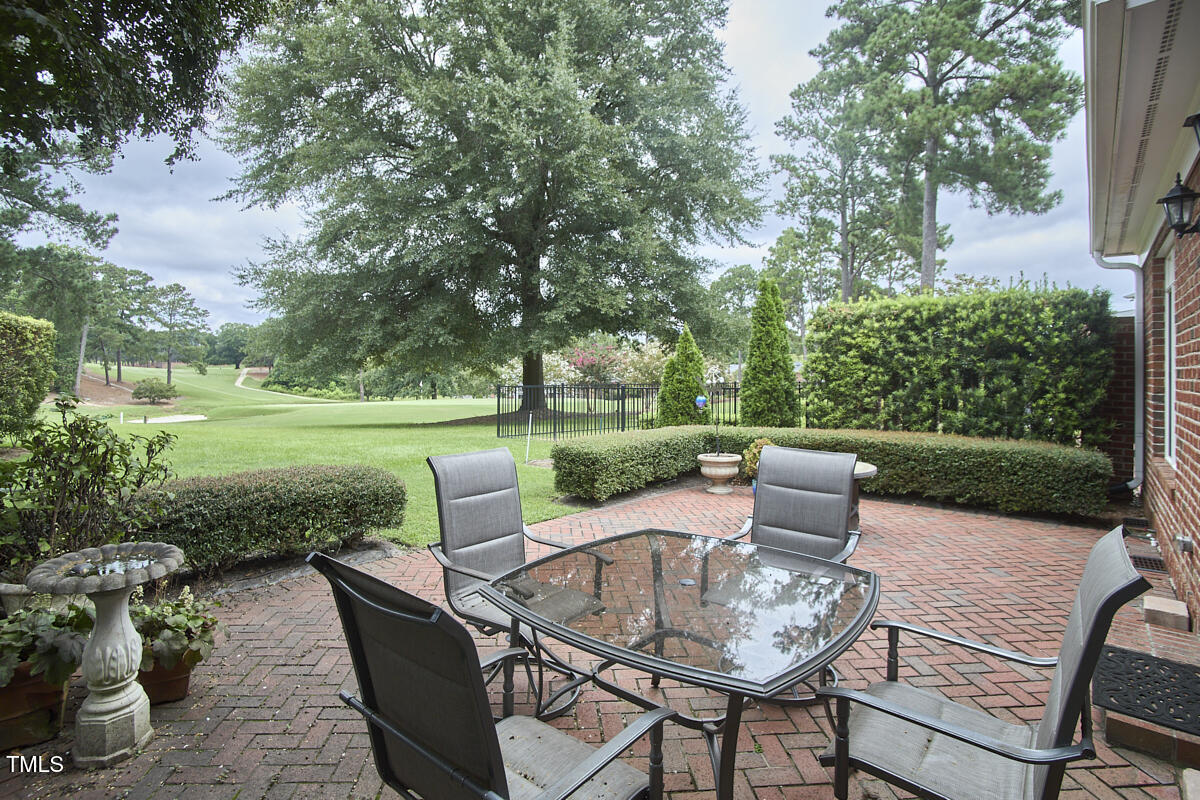 1344 Longleaf Drive Fayetteville, NC 28305 - Photo 41 of 46 a view of a patio with a table chairs and a backyard