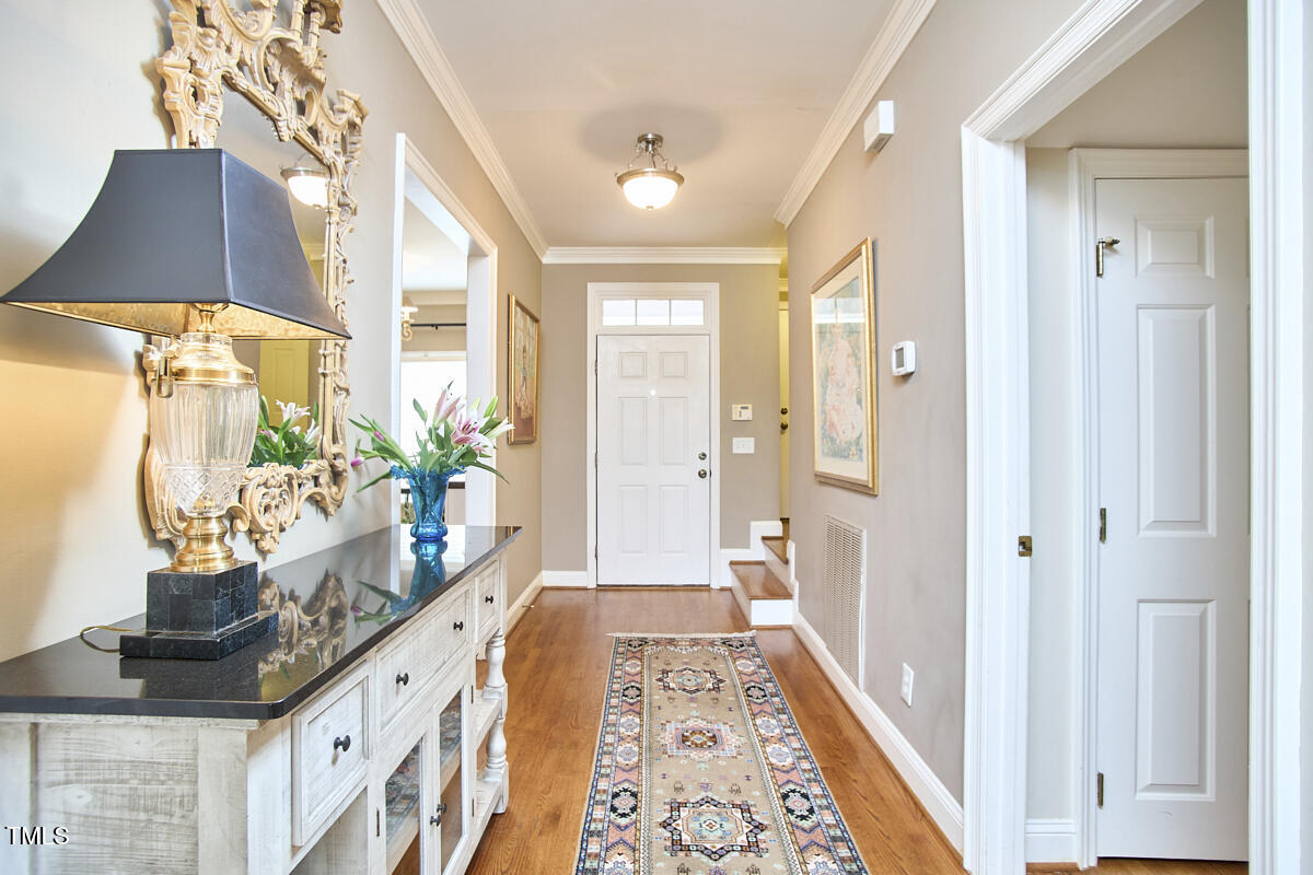 1344 Longleaf Drive Fayetteville, NC 28305 - Photo 6 of 46 a view of hallway with wooden floor and a potted plant