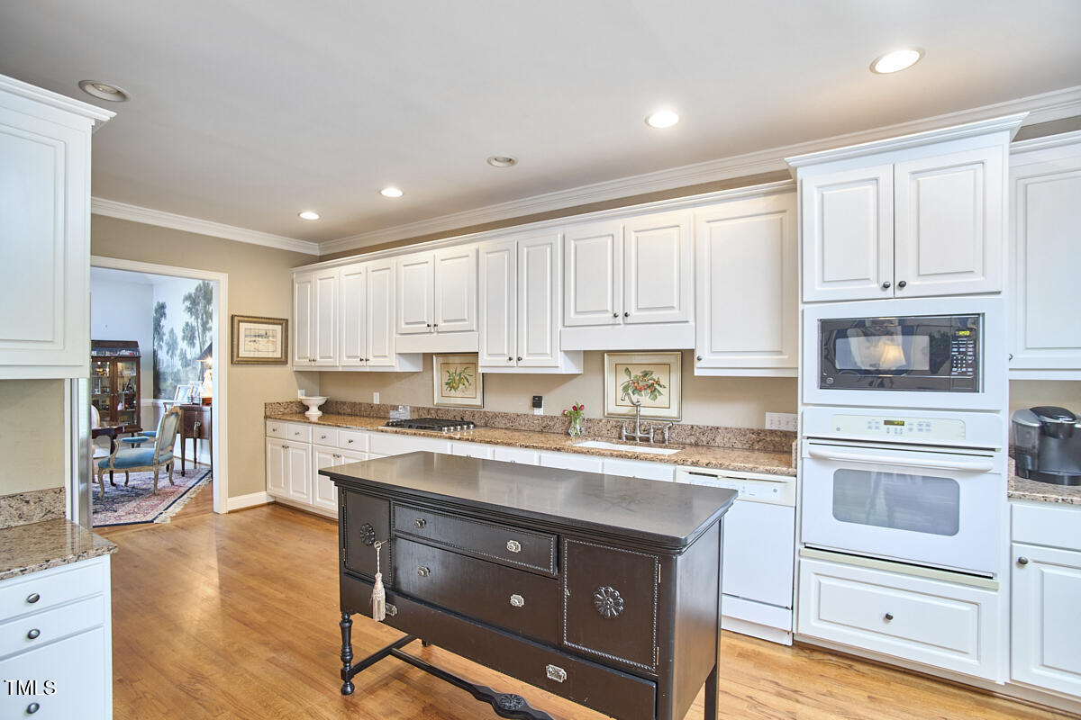 1344 Longleaf Drive Fayetteville, NC 28305 - Photo 7 of 46 a kitchen with a stove a sink and a refrigerator