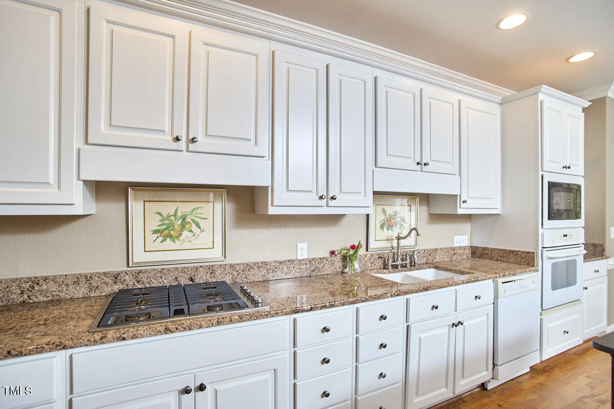 1344 Longleaf Drive Fayetteville, NC 28305 - Photo 8 of 46 a kitchen with granite countertop white cabinets and a sink