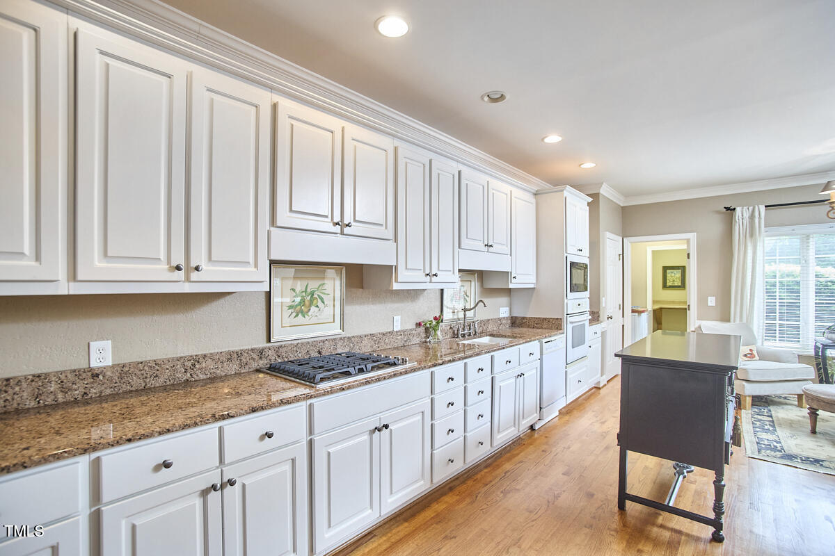 1344 Longleaf Drive Fayetteville, NC 28305 - Photo 10 of 46 a kitchen with granite countertop white cabinets and stainless steel appliances
