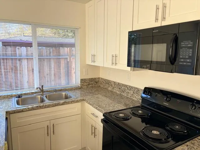 a kitchen with a stove and a sink