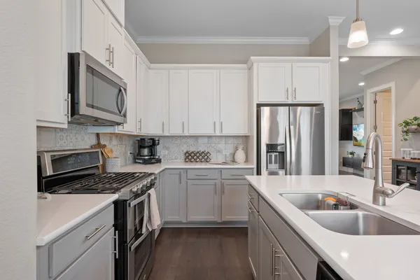 a kitchen with a stove and wooden floor