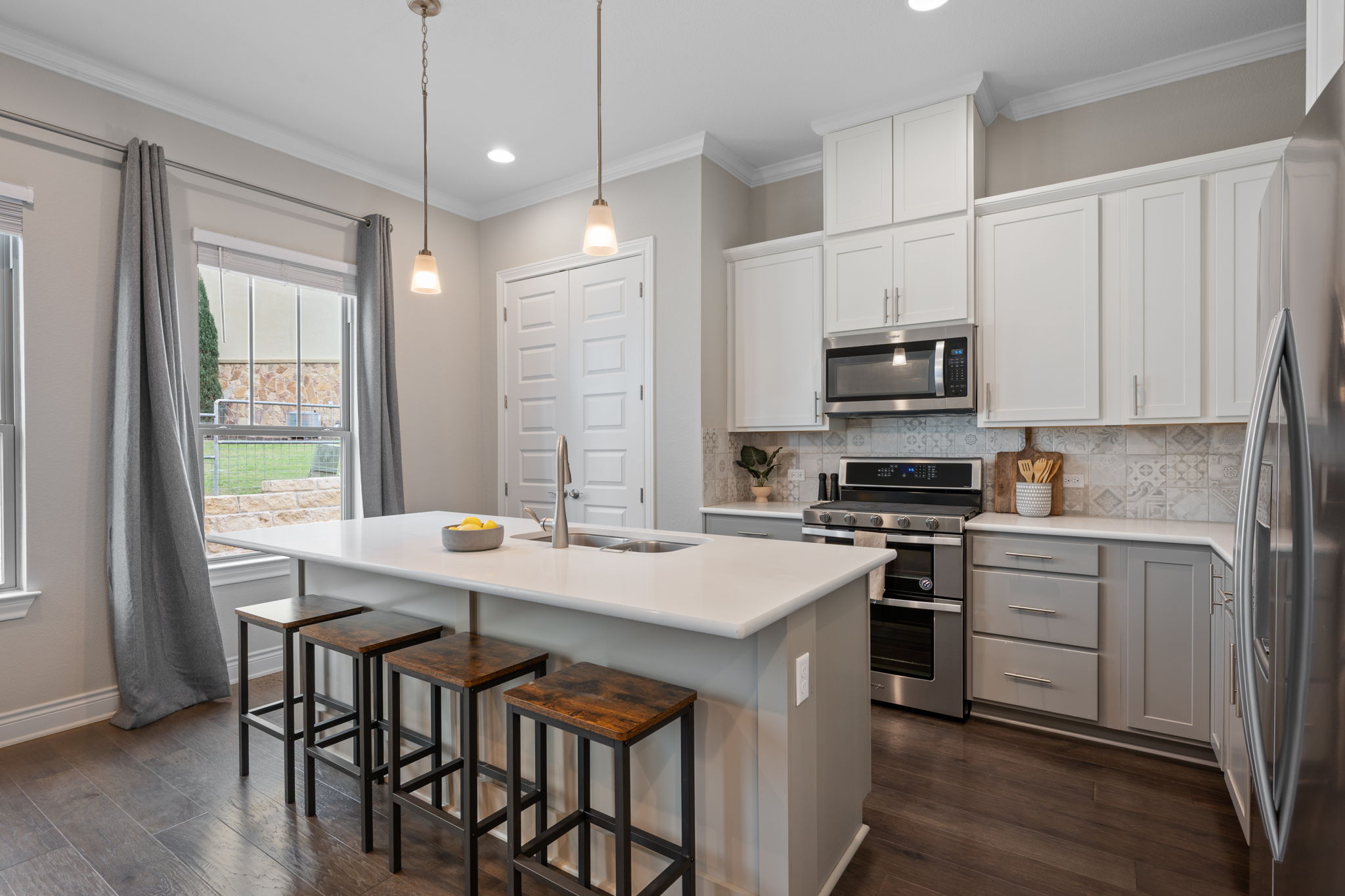 308 Adams Street Georgetown, TX 78628 - Photo 15 of 39 a kitchen with stainless steel appliances a stove a sink a microwave a refrigerator and white cabinets