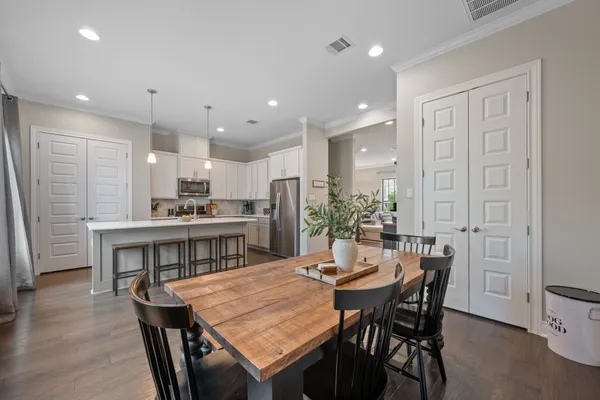 a view of a dining room with furniture and wooden floor