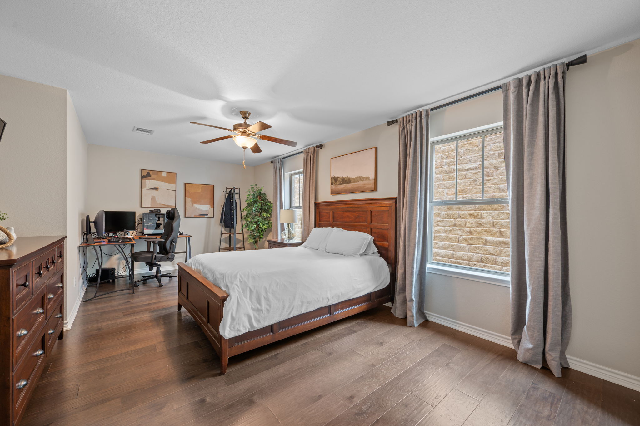 308 Adams Street Georgetown, TX 78628 - Photo 21 of 39 a spacious bedroom with a bed and a table in it