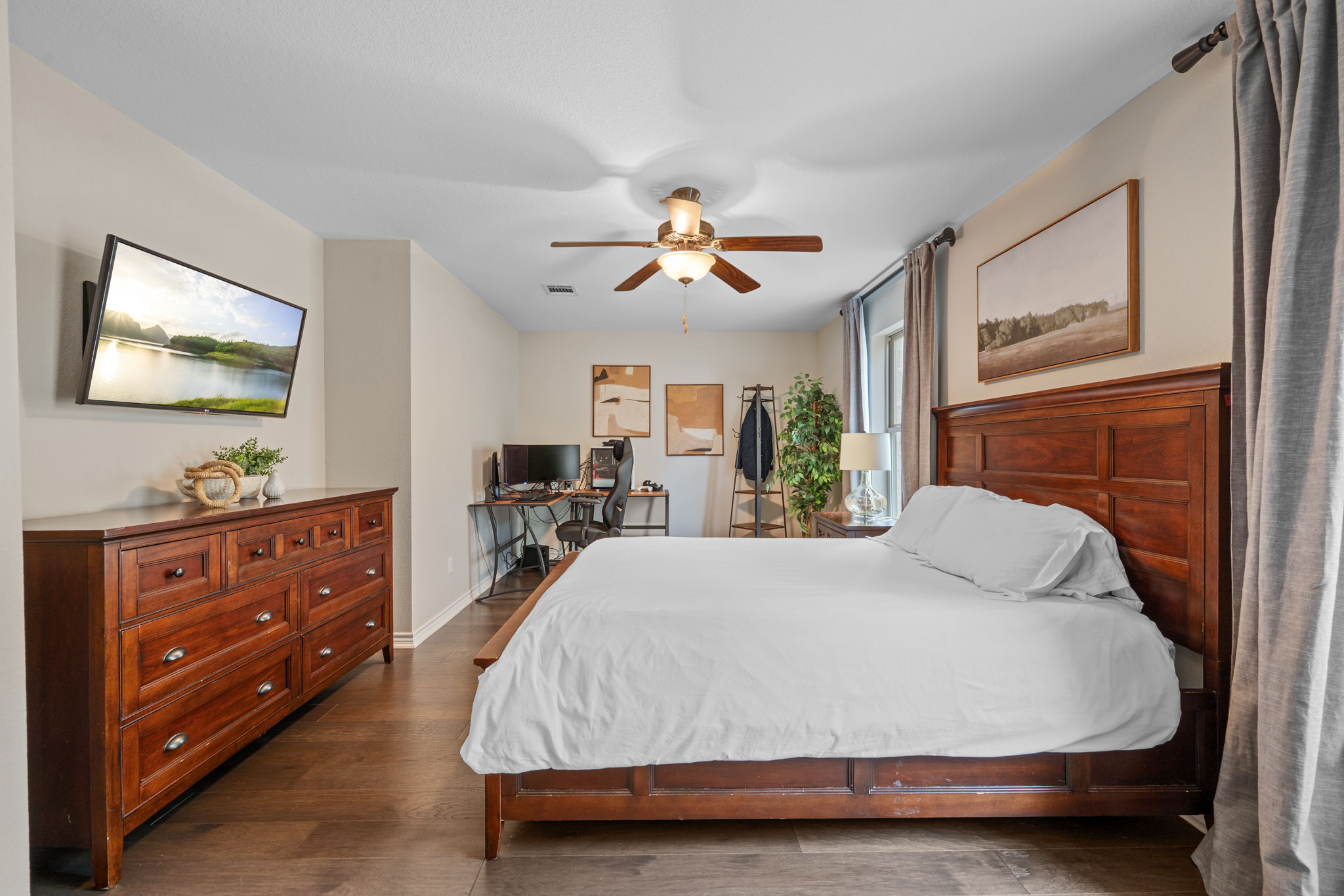 308 Adams Street Georgetown, TX 78628 - Photo 22 of 39 a bed room with a bed and a flat screen tv