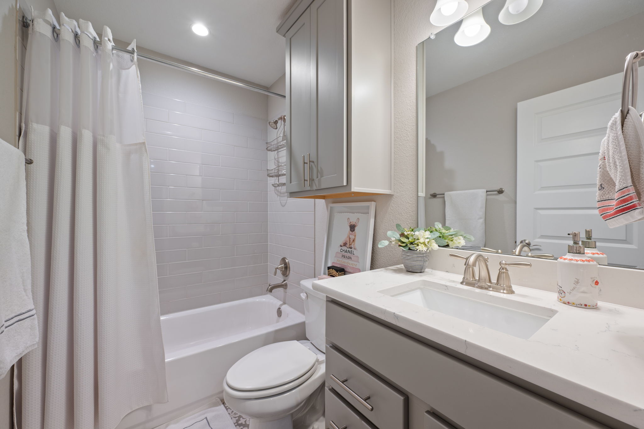 308 Adams Street Georgetown, TX 78628 - Photo 24 of 39 a bathroom with a granite countertop sink a toilet a mirror and shower