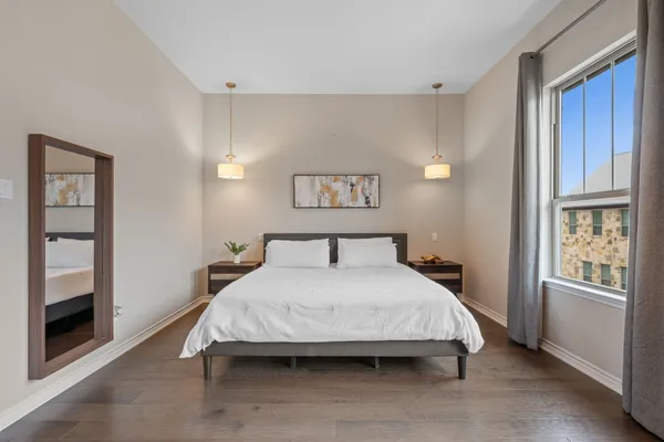 a bedroom with a bed and a chandelier