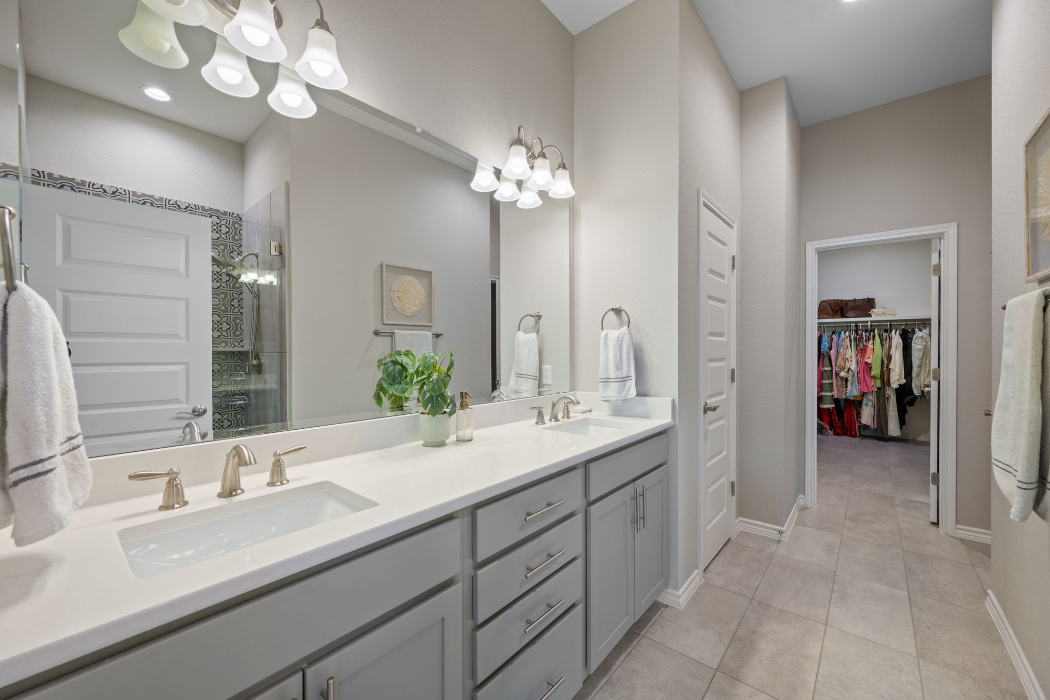 308 Adams Street Georgetown, TX 78628 - Photo 28 of 39 a spacious en suite bathroom with a granite countertop sink a light fixture and a mirror