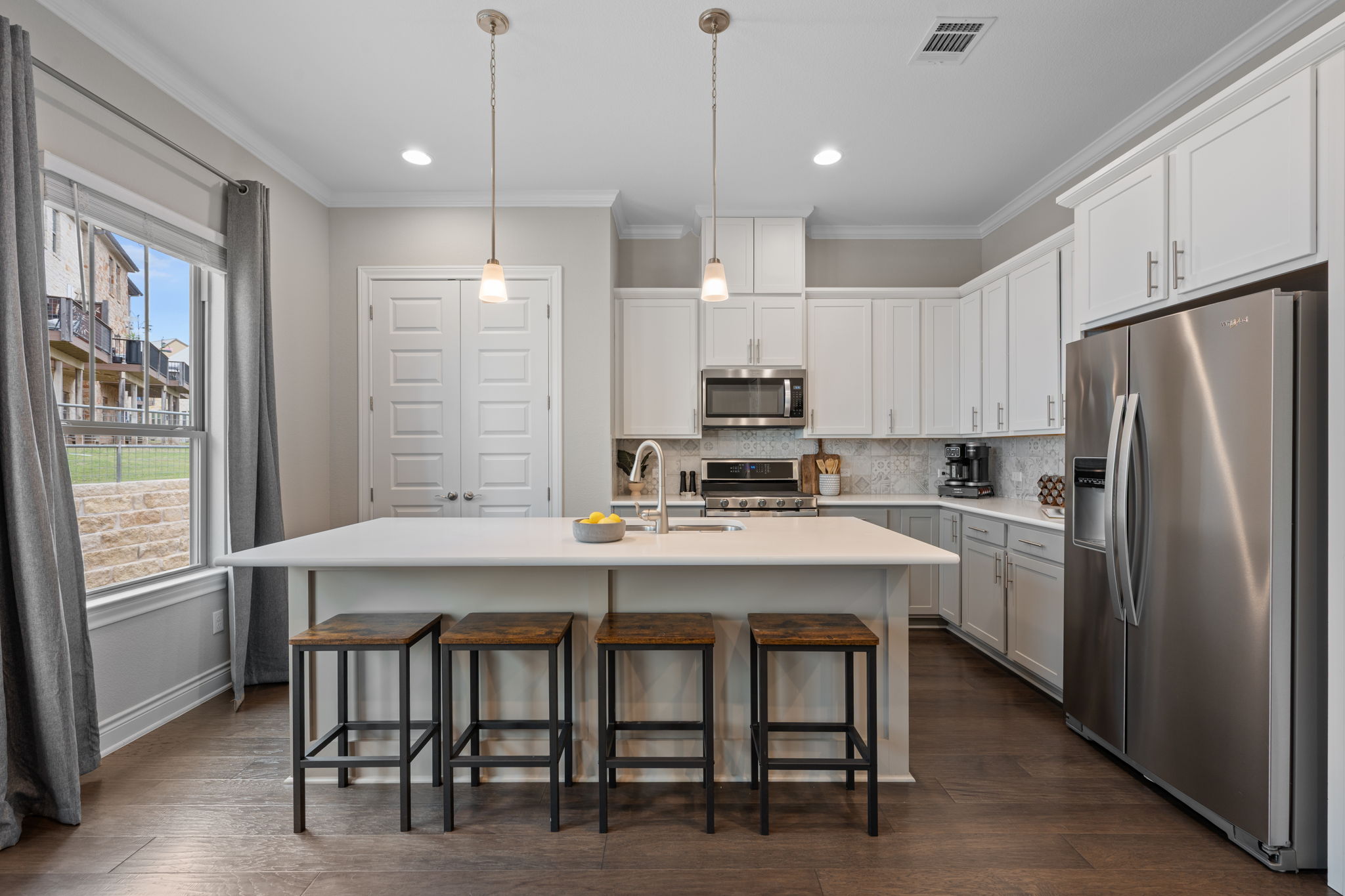 308 Adams Street Georgetown, TX 78628 - Photo 10 of 39 a kitchen with kitchen island a appliances dining table and chairs