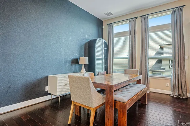 a view of a dining room with furniture and wooden floor