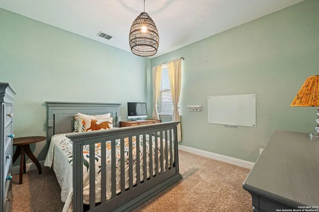 a view of a bedroom with furniture and windows