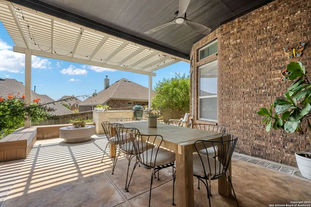 a view of a patio with a dining table and chairs with wooden floor