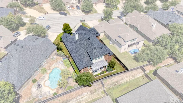 an aerial view of a house with a garden and swimming pool
