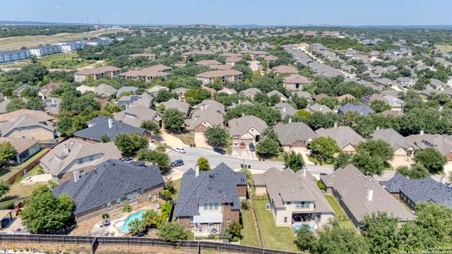 an aerial view of residential houses with outdoor space