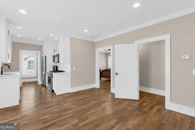 a view of a kitchen with furniture and wooden floor