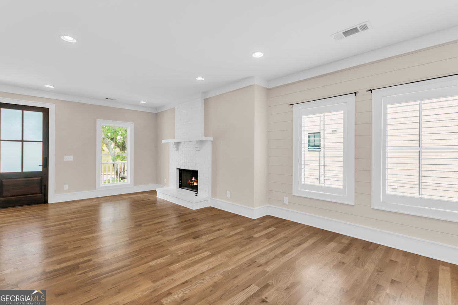 205 Flesner Court Clarkesville, GA 30523 - Photo 16 of 41 an empty room with windows fireplace and wooden floor