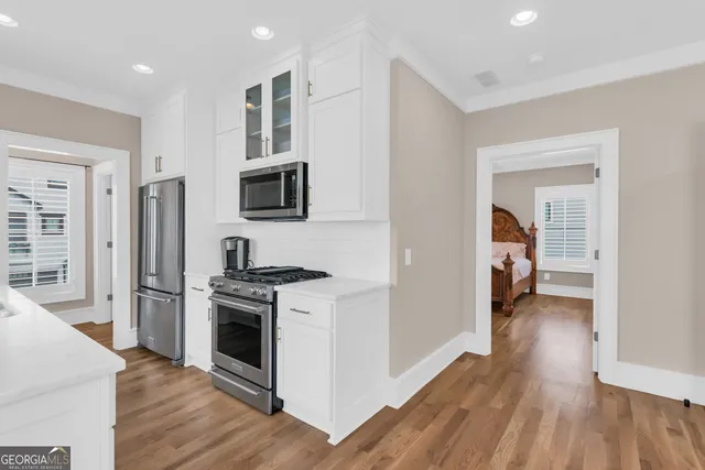 a kitchen with a stove and a refrigerator