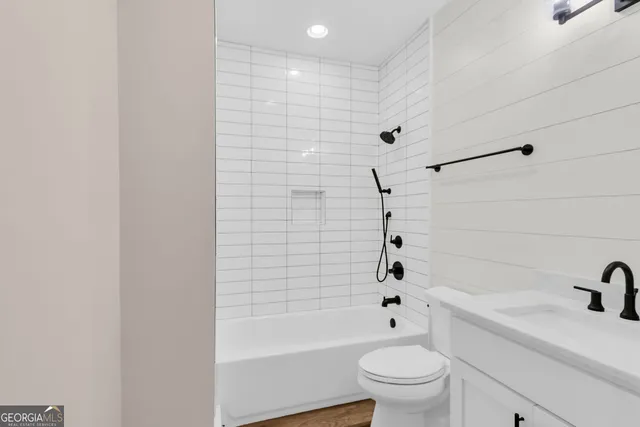 a bathroom with a bathtub a sink a toilet and a window