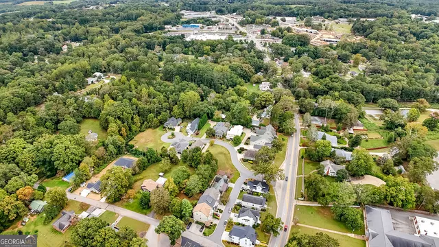 an aerial view of residential houses with yard