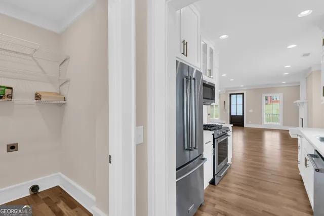 a kitchen with stainless steel appliances granite countertop a refrigerator and a sink