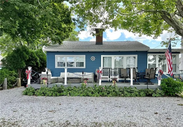 a front view of a house with garden and porch