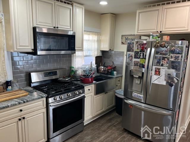 210 Washington Avenue Edison, NJ 08817 - Photo 3 of 5 a kitchen with stainless steel appliances granite countertop a stove and a refrigerator