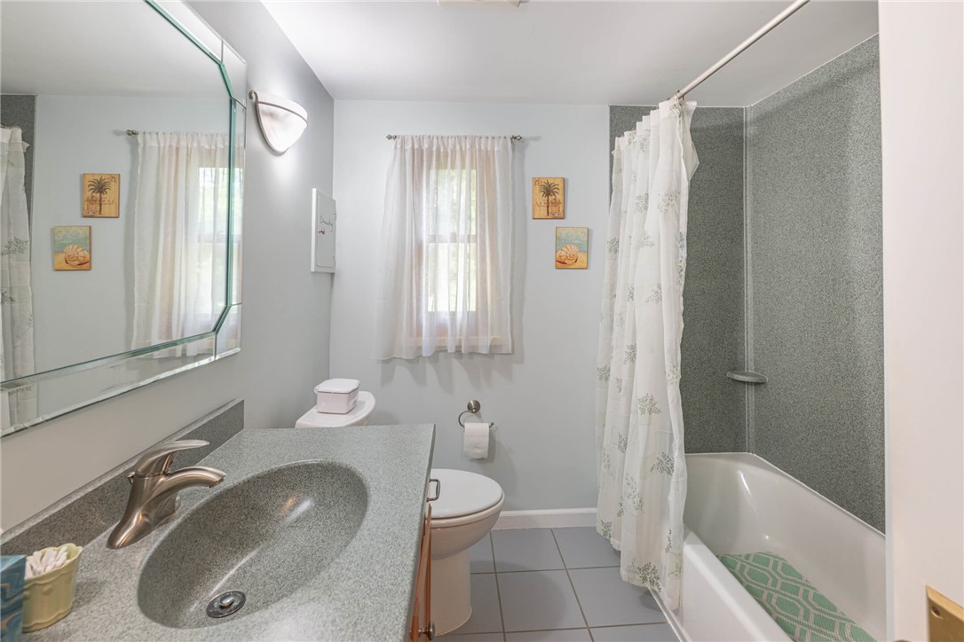 156 West Hadley Road Dayton, OH 45419 - Photo 35 of 71 This bright bathroom features a vanity, window, and shower-tub combination.