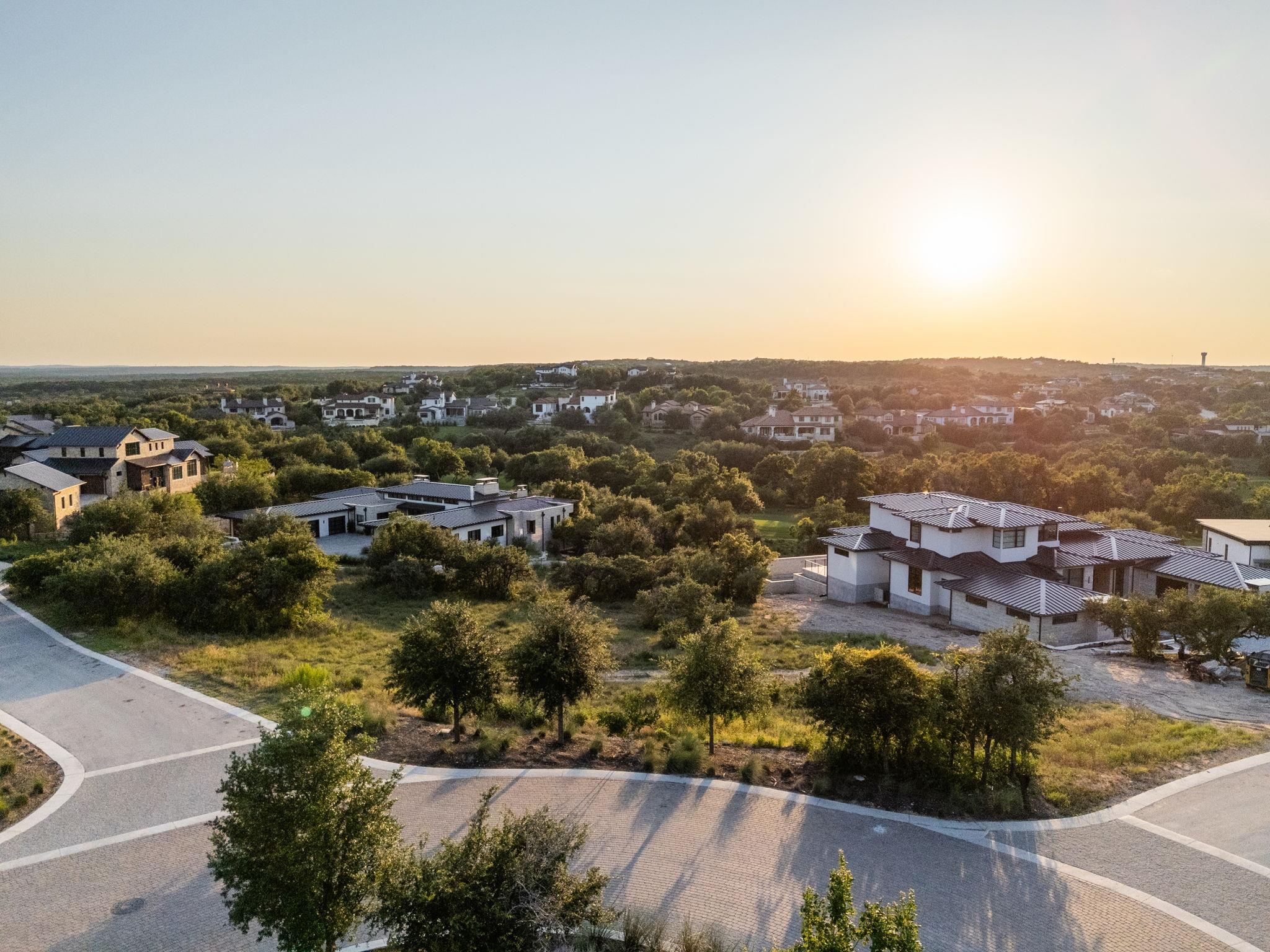 an aerial view of residential houses with city view