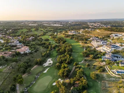 an aerial view of residential houses with city view
