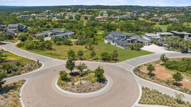 an aerial view of a house with a yard and lake view