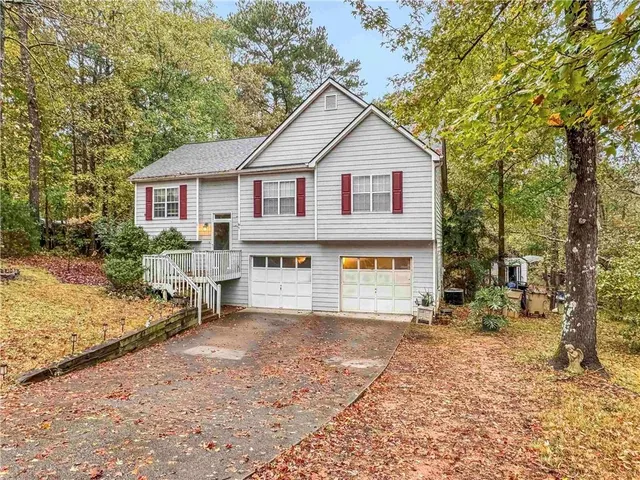 a view of house with outdoor space and sitting area